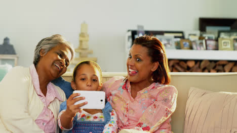 Happy-family-using-smartphone-in-living-room-4k