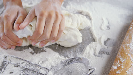 Woman-kneading-a-dough-4k
