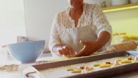 Senior-woman-preparing-cookies-in-kitchen-4k