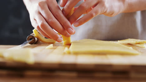 Woman-slicing-dough-on-chopping-board-4k