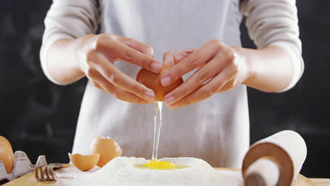Woman-breaking-eggs-in-the-flour-4k