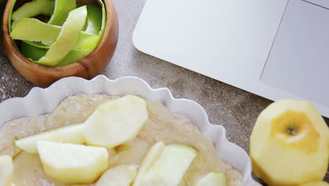 Laptop-with-apple-tart-and-peeled-green-apple-4k