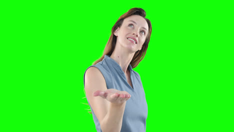 Caucasian-woman-raising-hand-on-green-background