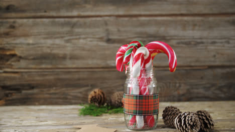 Pine-cones-and-candy-cane-arranged-in-a-jar-4k