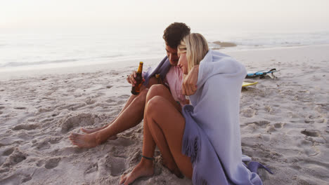 Portrait-of-a-Caucasian-couple-enjoying-time-at-the-beach