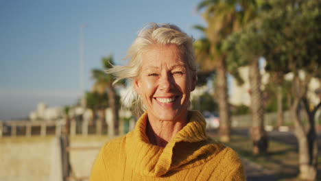 Front-view-of-senior-woman-alongside-beach
