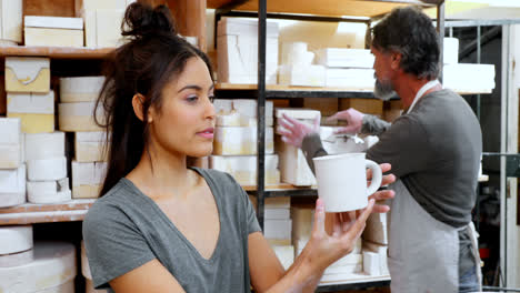 Female-potter-checking-mug-4k