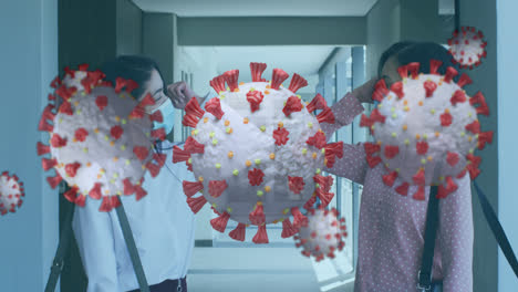 Animation-of-floating-covid-19-cells-with-colleagues-greeting-in-office-wearing-face-masks