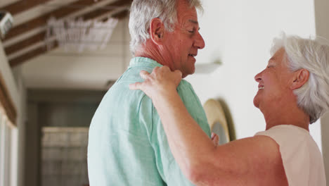 Happy-senior-caucasian-couple-dancing-together-at-home