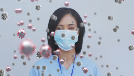 Animation-of-floating-covid-19-cells-with-female-doctor-wearing-face-masks