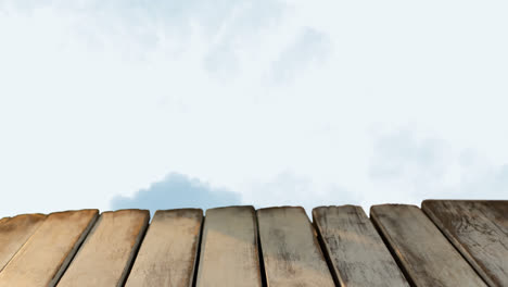 Animation-of-wooden-boards-over-clouds-