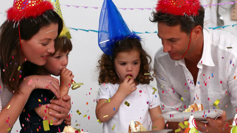 Animation-of-multi-coloured-confetti-falling-over-family-in-party-hats