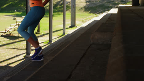 Low-section-of-female-athlete-exercising-on-steps-at-sports-venue-4k