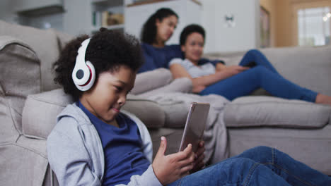 Mixed-race-girl-using-tablet-wearing-headphones