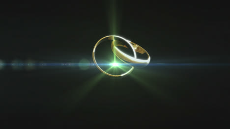 Two-golden-rings-spinning-against-black-background