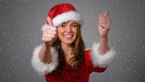 Video-composition-with-falling-snow-over-happy-girl-in-santas-suit-showing-thumbs-up