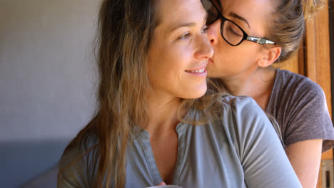 Lesbian-couple-embracing-each-other-at-home-4k
