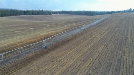 Aerial-view-of-irrigation-sprinkles-used-in-harvested-field-4k