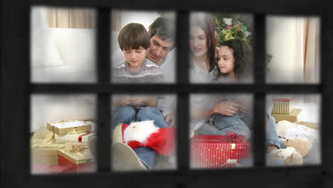 Family-at-Christmas-seen-through-window