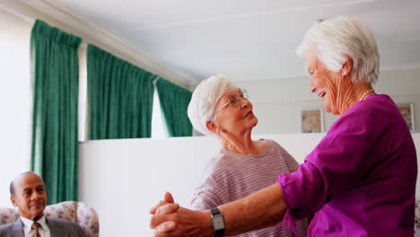 Side-view-of-active-Caucasian-female-senior-women-dancing-together-at-nursing-home-4k