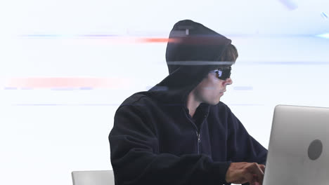 Caucasian-hooded-hacker-man-with-a-laptop-over-rays-glowing