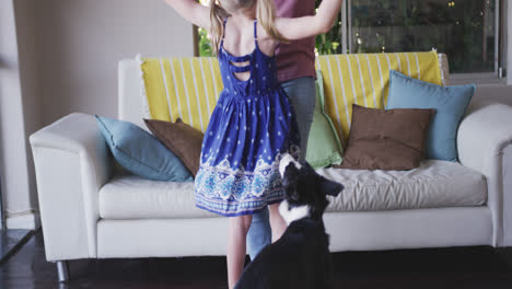 Front-view-of-Caucasian-woman-dancing-with-her-daughter-at-home