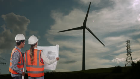 Animation-of-wind-turbine-turning,-male-and-female-engineers-reading-plans-with-countryside