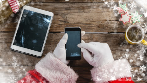 Santa-Usando-Teléfono-Y-Tableta-Con-Copos-De-Nieve