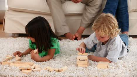 Zap-text-on-speech-bubble-against-kids-playing-jenga-game-at-home