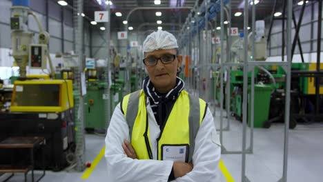 Warehouse-female-worker-looking-at-camera-with-arms-crossed