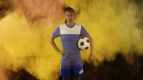 Female-soccer-player-against-smoke-explosion-in-background