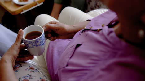 Close-up-of-active-senior-woman-drinking-coffee-at-nursing-home-4k