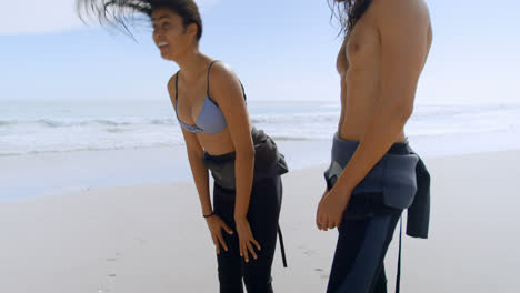 Surfer-couple-enjoying-on-the-beach-4k