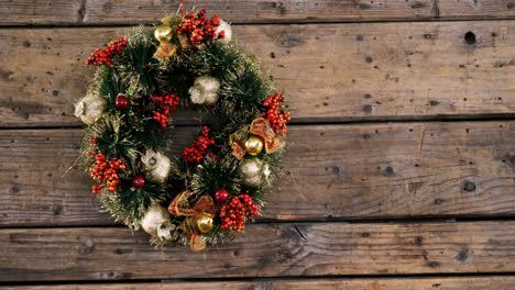 Christmas-wreath-on-wooden-table-4k