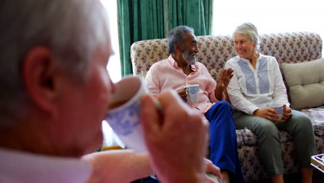 Close-up-of-active-Caucasian-senior-man-drinking-coffee-at-nursing-home-4k