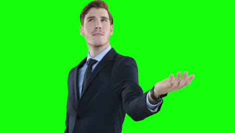 Caucasian-man-looking-up-and-raising-hand-on-green-background