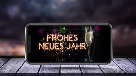 Animation-of-frohes-neues-jahr-text-and-glass-of-champagne-on-smartphone-screen-and-fireworks