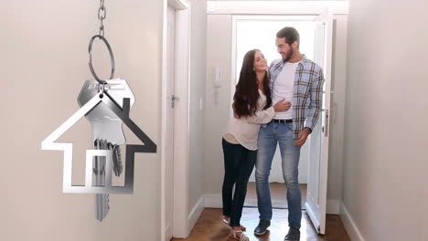 House-keys-and-key-fob-hanging-with-couple-in-new-home-in-the-background