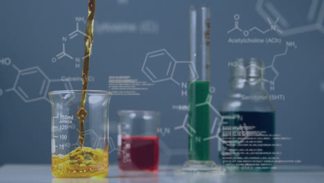 Coloured-liquids-in-containers-on-lab-bench-with-moving-data