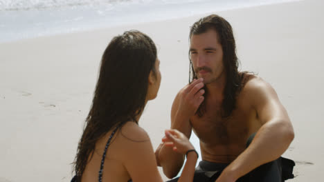 Surfer-couple-talking-on-the-beach-4k