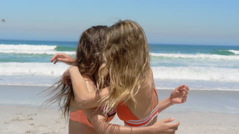 Young-female-friends-in-bikini-dancing-together-4k