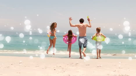 Moving-spots-of-white-light-with-family-on-beach