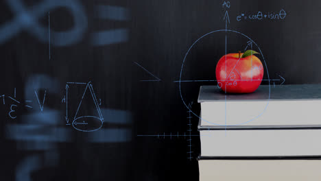 Apfel-Auf-Einem-Stapel-Bücher-Und-Mathematische-Gleichungen-Und-Graphen