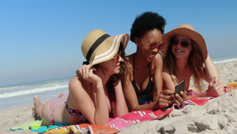 Young-female-friends-having-fun-at-beach-4k