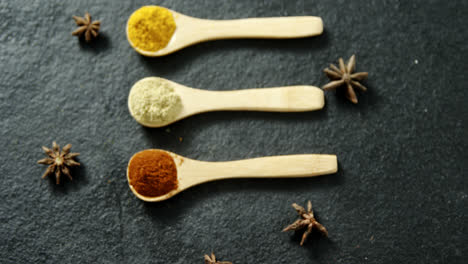 Star-anise-with-various-spices-powder-in-wooden-spoon-4k