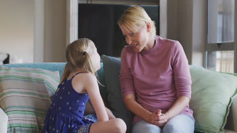 Caucasian-woman-talking-with-her-daughter-at-home