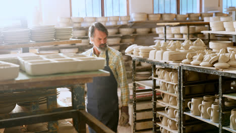 Male-potter-checking-pottery-4k