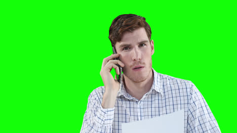 Caucasian-man-talking-by-phone-on-green-background