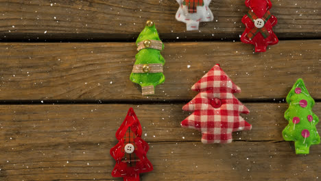 Falling-snow-with-Christmas-tree-decorations-on-wood