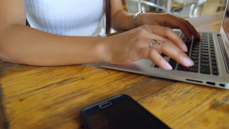 Teenage-girl-using-laptop-in-restaurant-4k